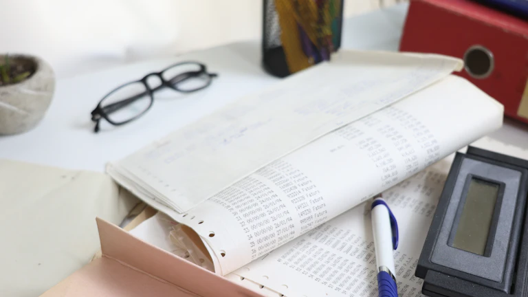 계산기와 펜이 놓인 서류